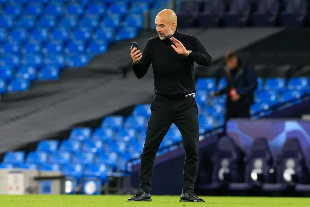 Pep Guardiola on his phone at the end of the game. We wonder which live score app he's checking?