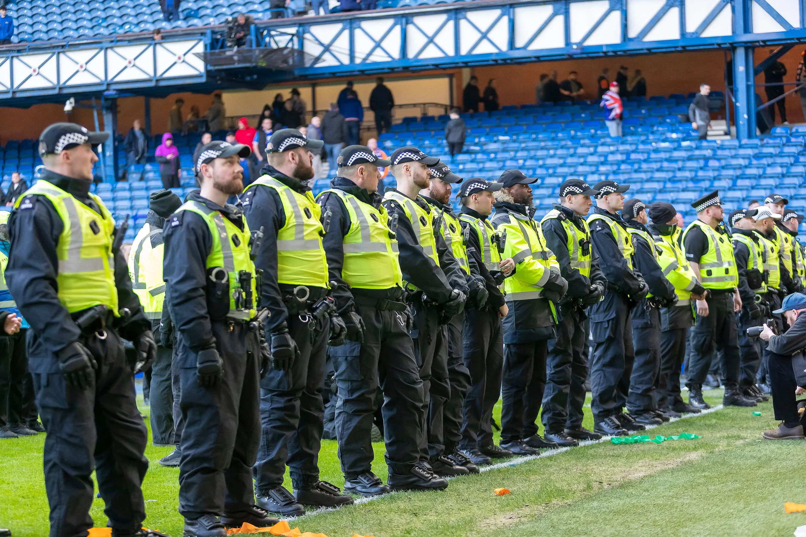 Police line the pitch at Ibrox during the Scottish Cup quarter-final between Celtic and Rangers