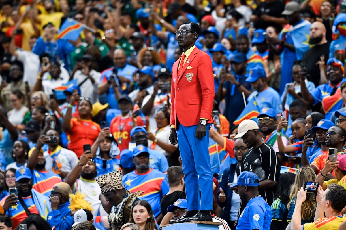 Democratic Republic of Congo fan Michel Kuka Mboladinga, mimicking the posture of the Patrice Lumumba statue at World Cup 2026