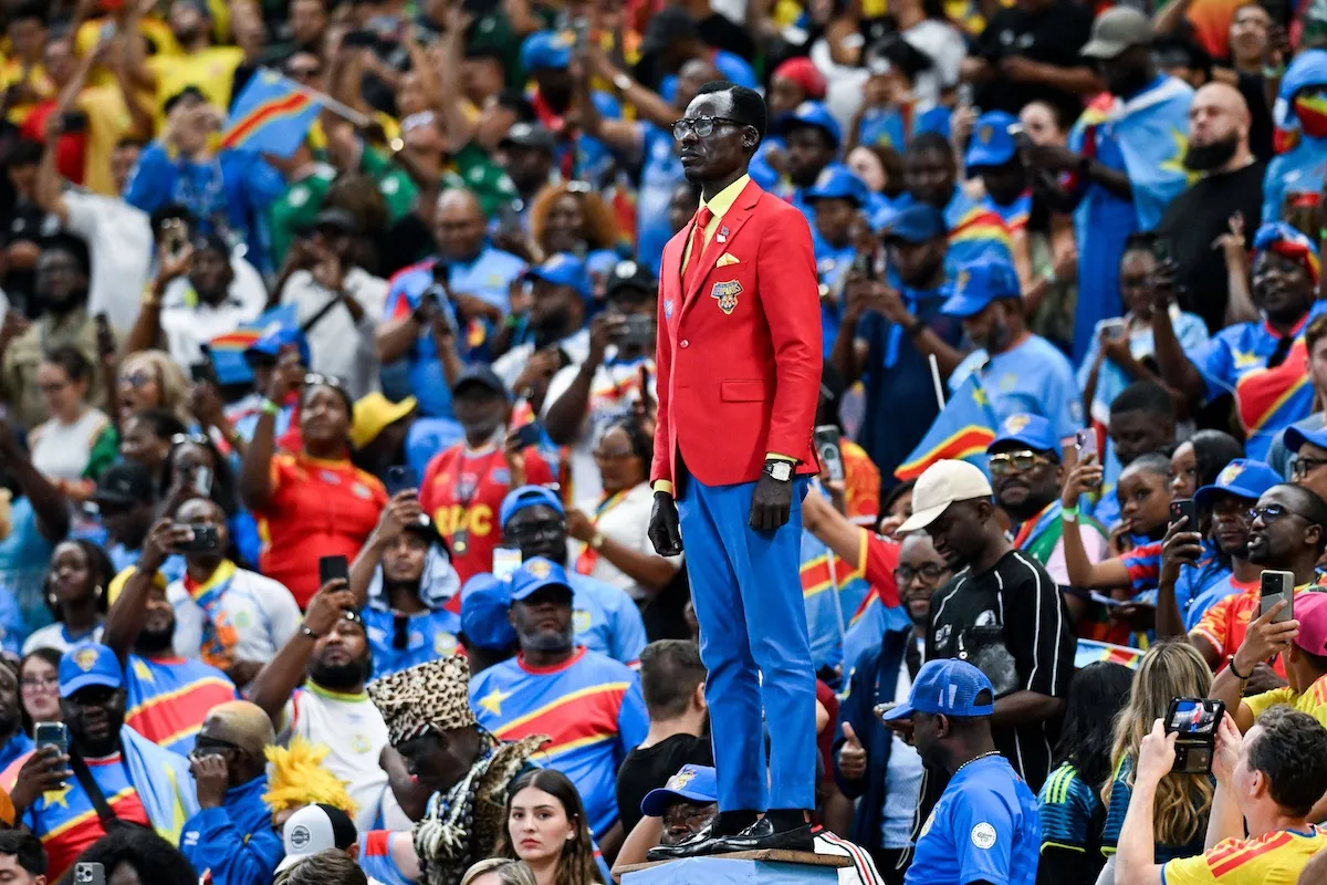 Democratic Republic of Congo fan Michel Kuka Mboladinga, mimicking the posture of the Patrice Lumumba statue at World Cup 2026
