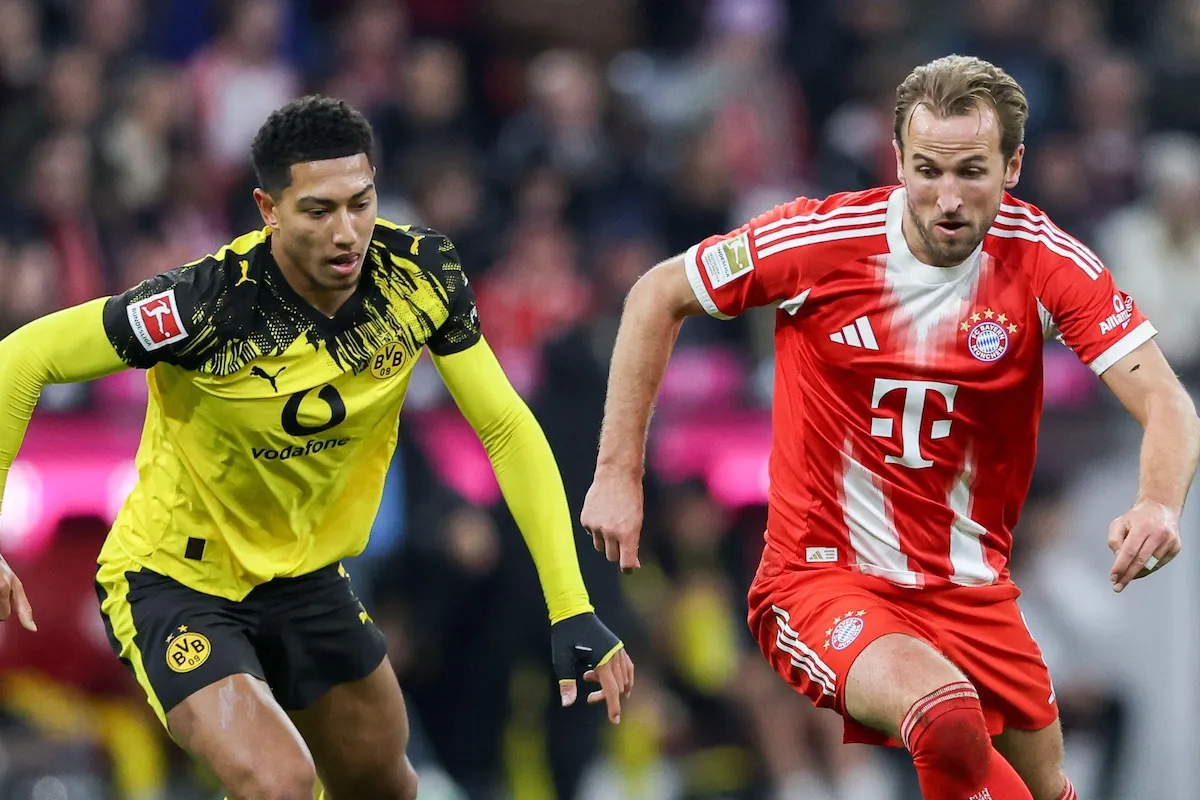 Jobe Bellingham of Borussia Dortmund and Harry Kane of Bayern Munich compete for the ball on October 18, 2025