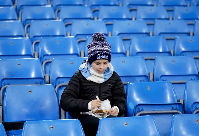 A young Manchester City enjoys a pie before a Premier League clash.