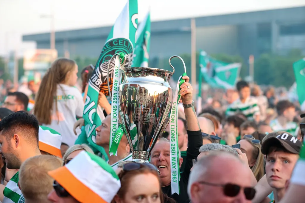 Celtic fans in Rotterdam | We could see similar scenes like: a Celtic fan holding up a UEFA Champions League replica trophy