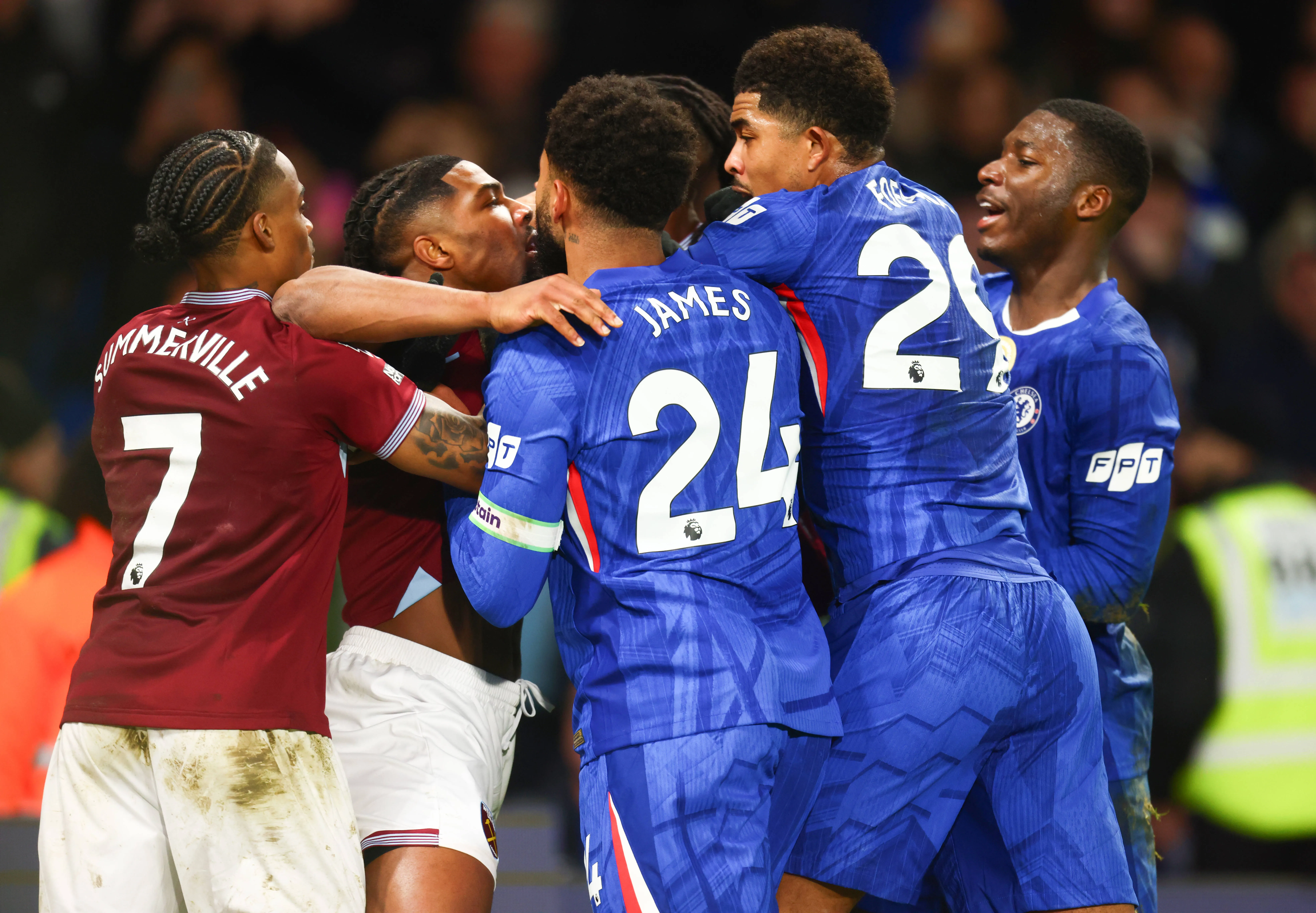 Players from Chelsea and West Ham clash during a Premier League game at Stamford Bridge