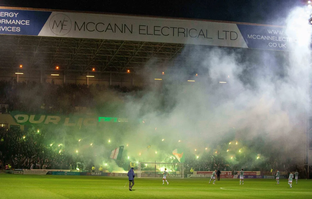 Celtic fans pyrotechnics and smoke fills the away end 