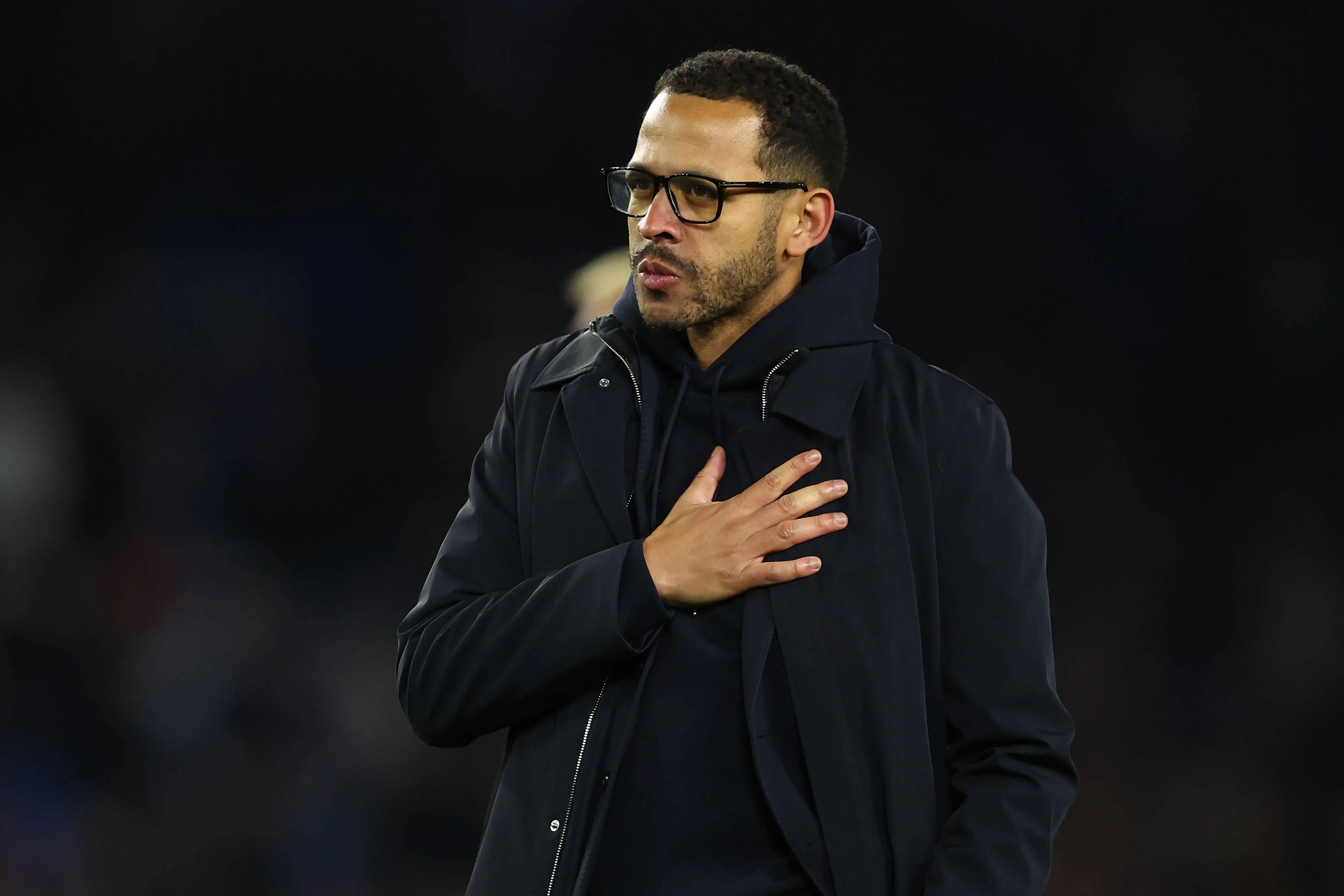 Liam Rosenior gestures towards Chelsea fans after losing to Brighton at the AMEX Stadium