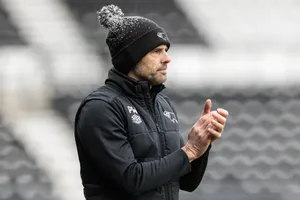 Derby fans on the pitch as they secure promotion back to the Championship