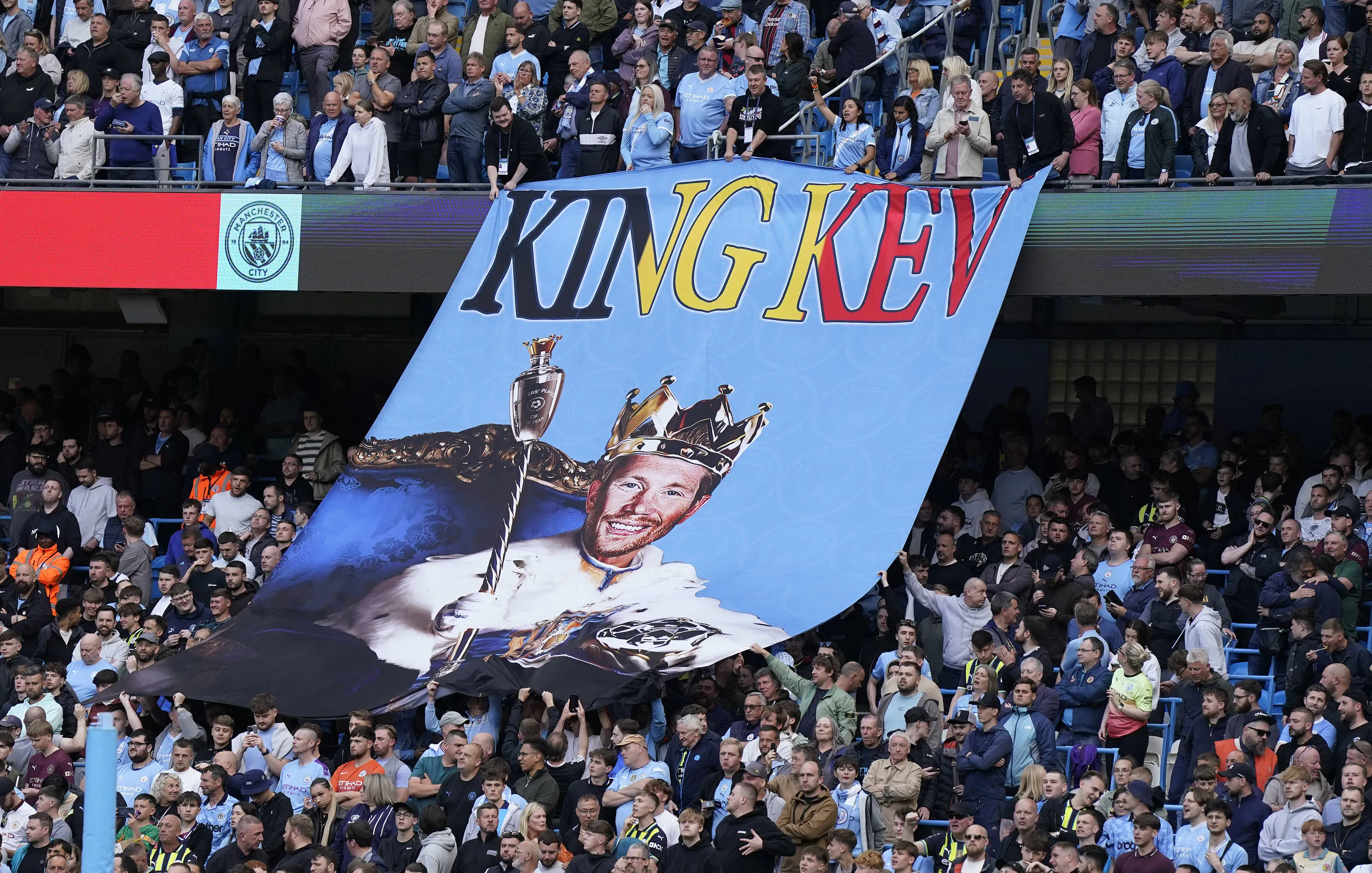 A giant banner is shown of Kevin De Bruyne of Manchester City