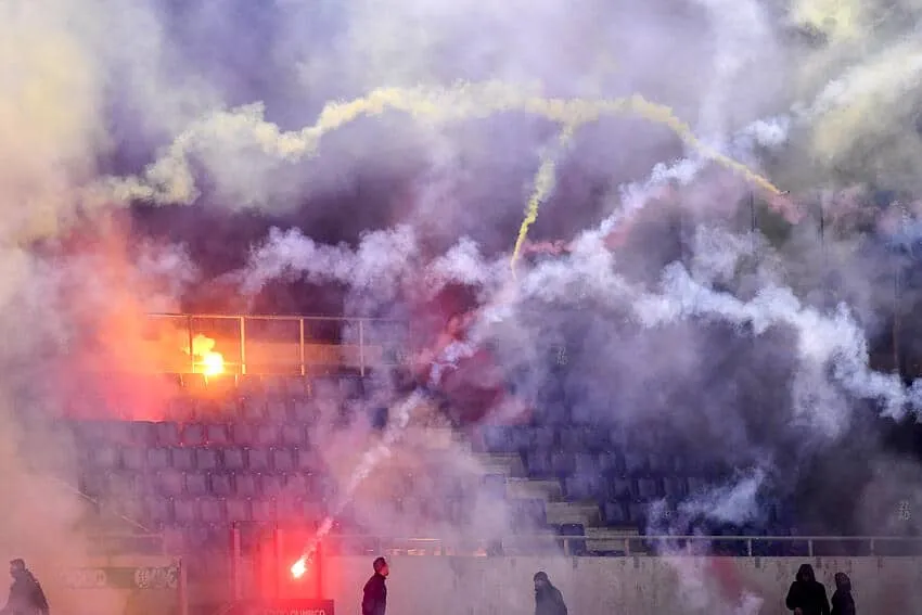 Lazio and Roma fans throw flares and smoke grenades at each other during the Italy cup football match between SS Lazio and AS Roma