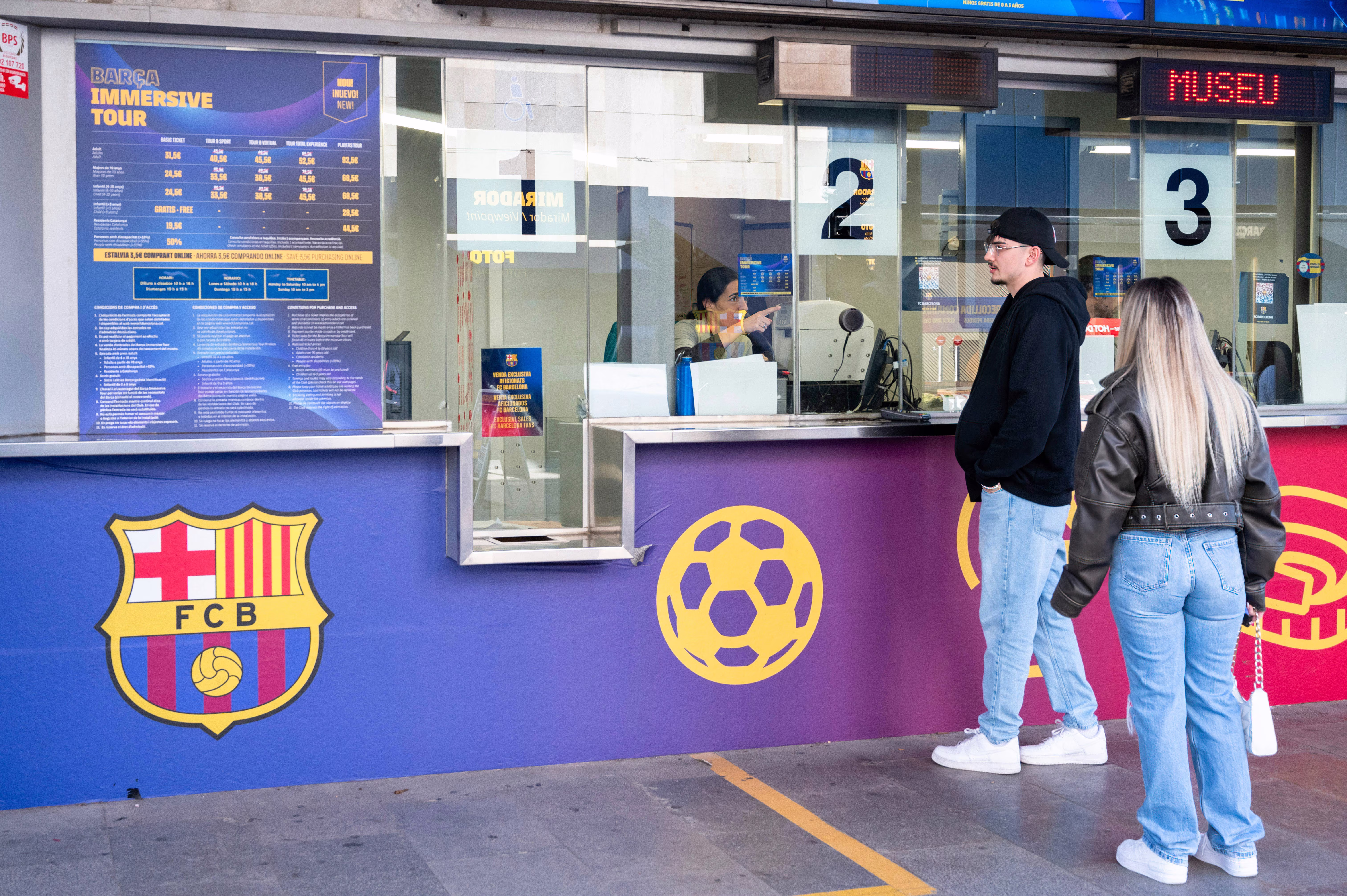 Barcelona fans buy tickets at the Camp Nou