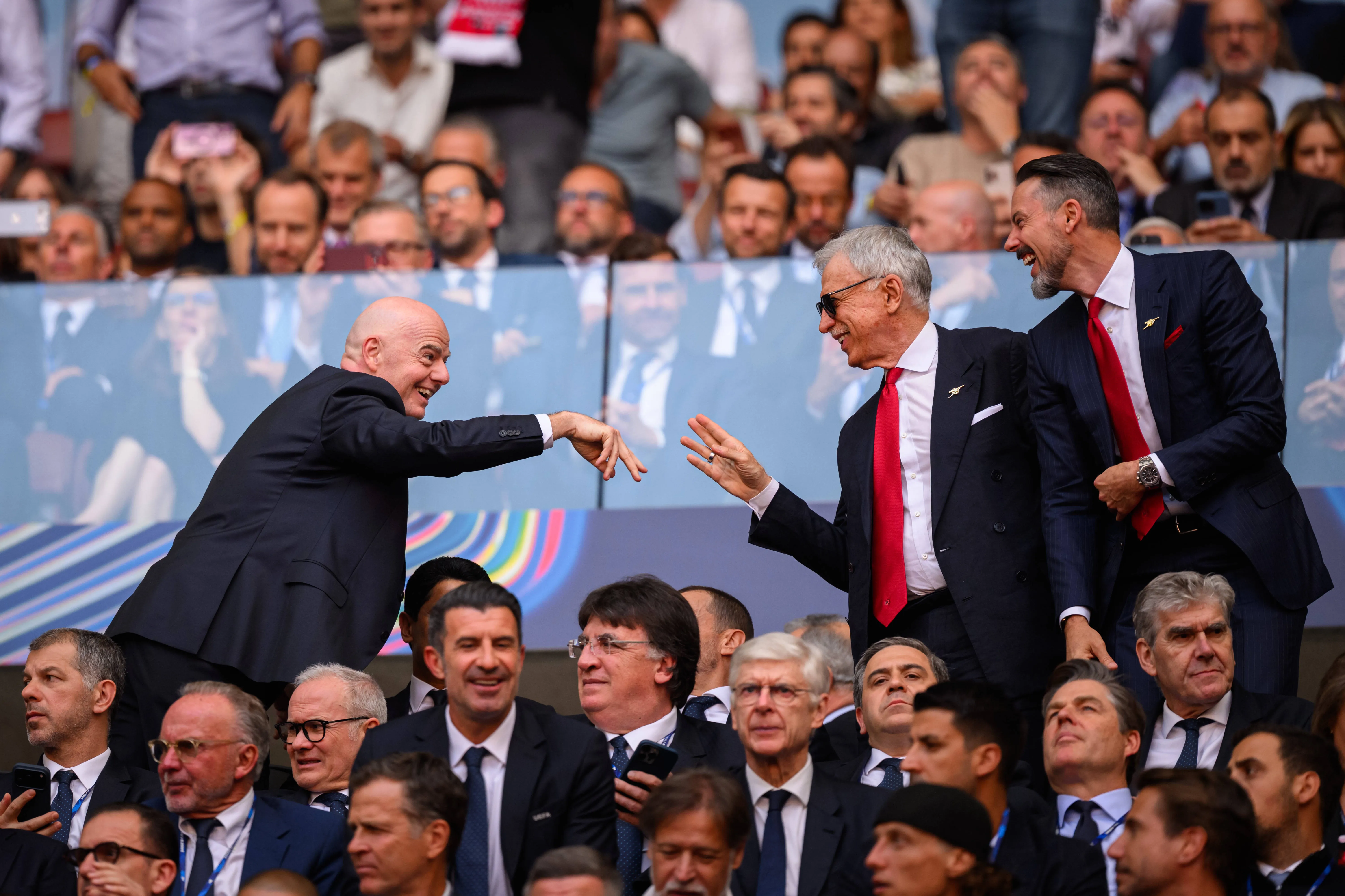 FIFA president Gianni Infantino greets Arsenal owners Stan and Josh Kroenke during Champions League final