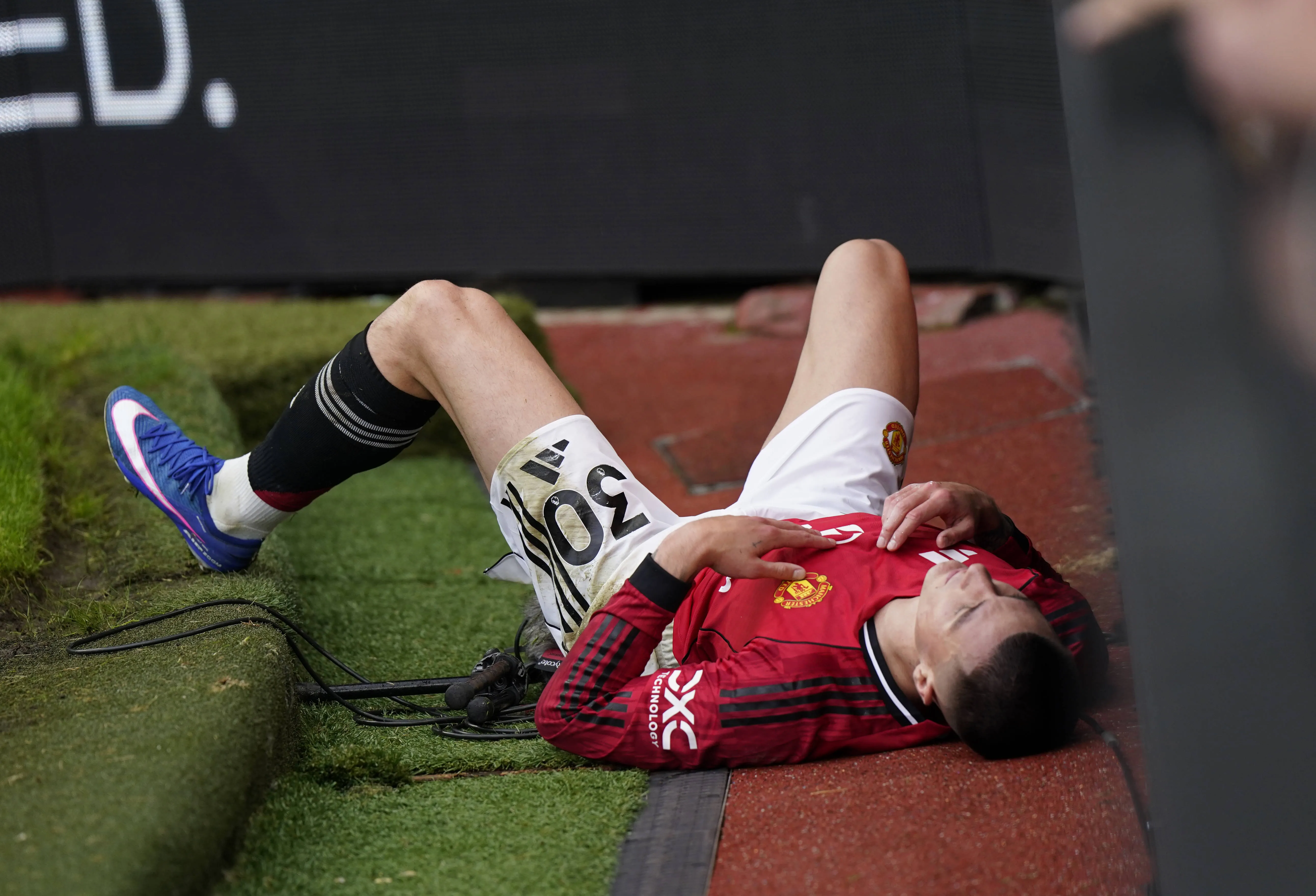 United forward Benjamin Sesko slides off the pitch after a challenge at Old Trafford