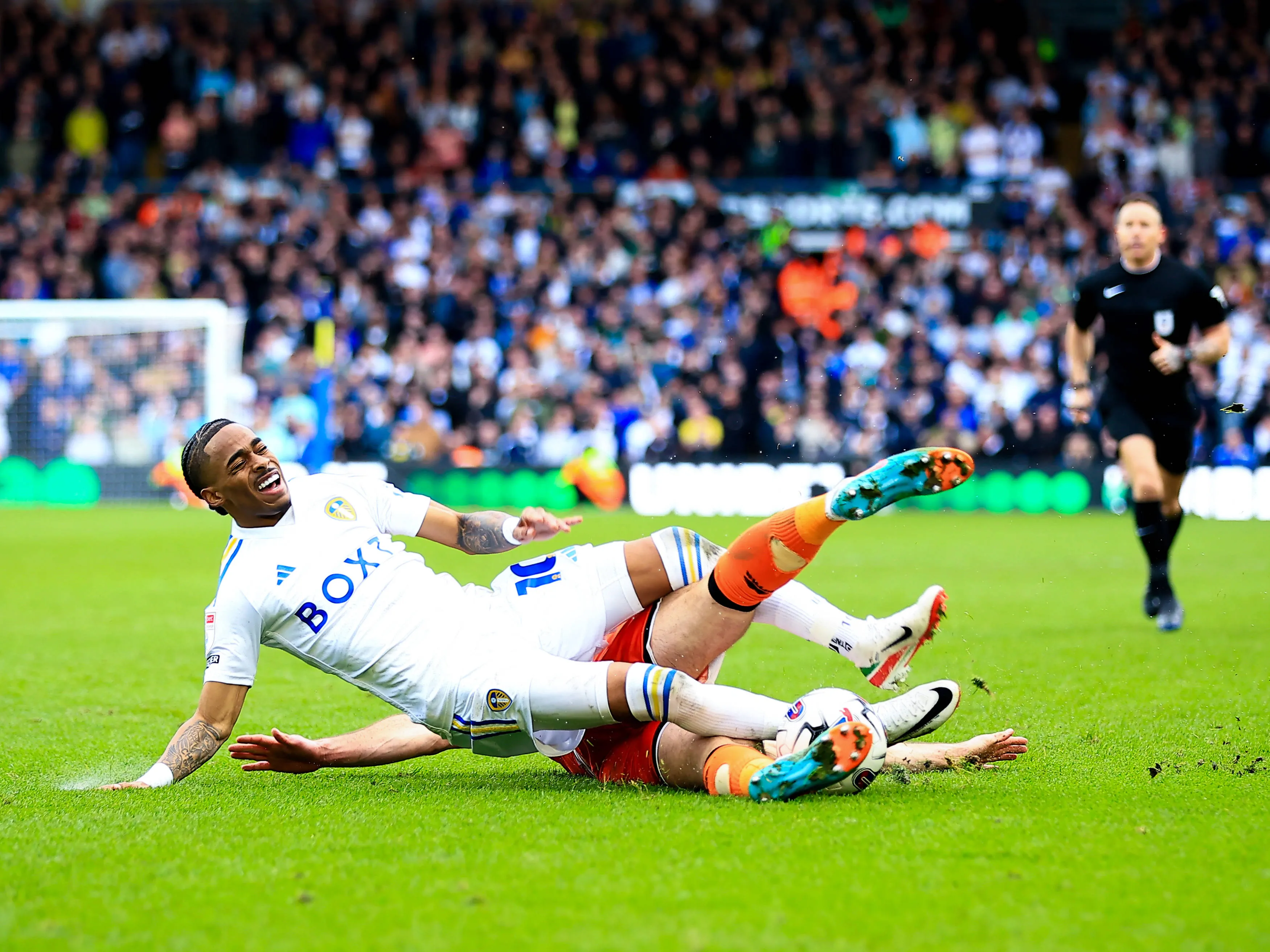 Crysencio Summerville of Leeds United is fouled by Ryan Leonard of Millwall