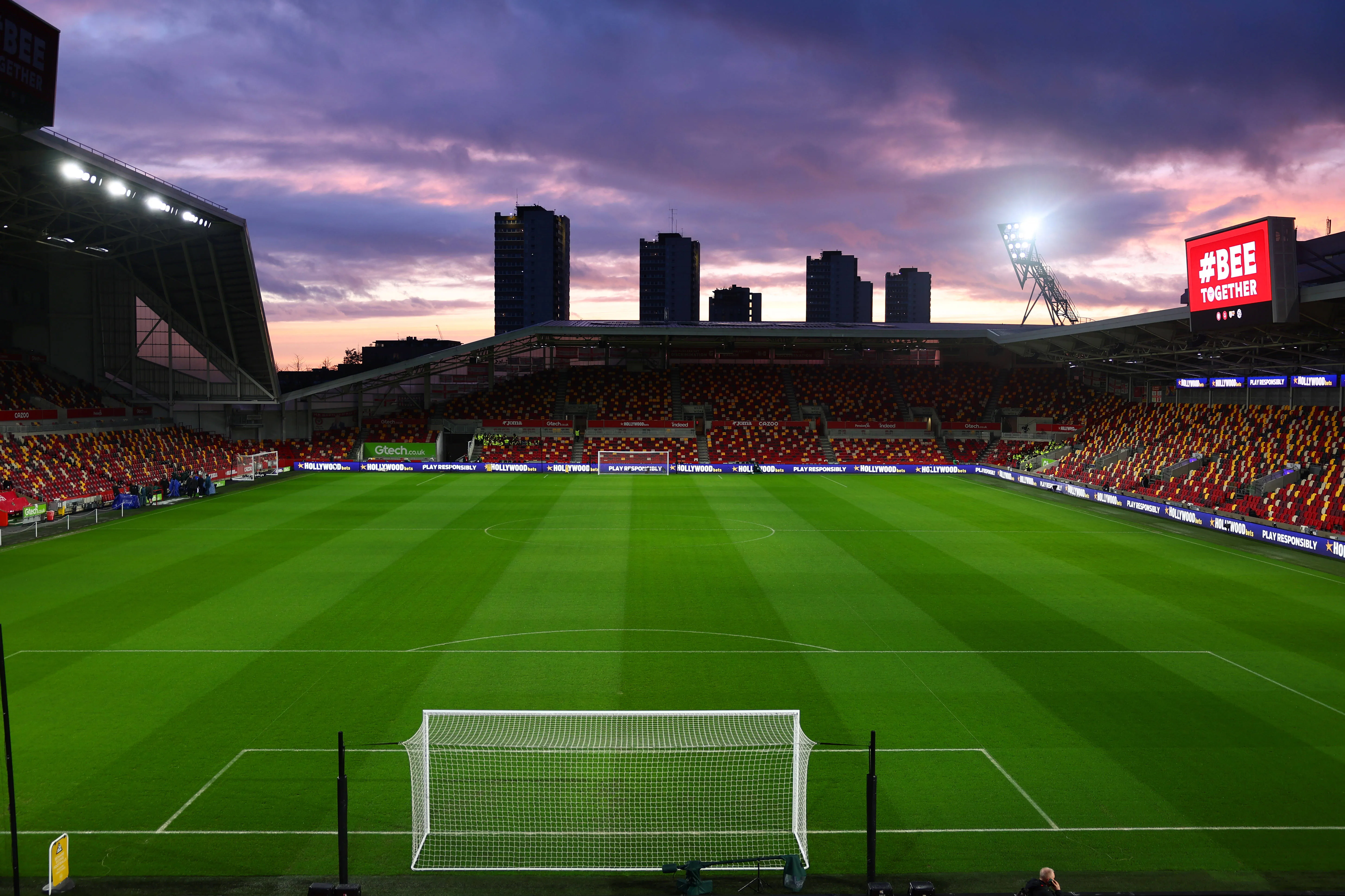 A view inside the Gtech Community Stadium with a sunset