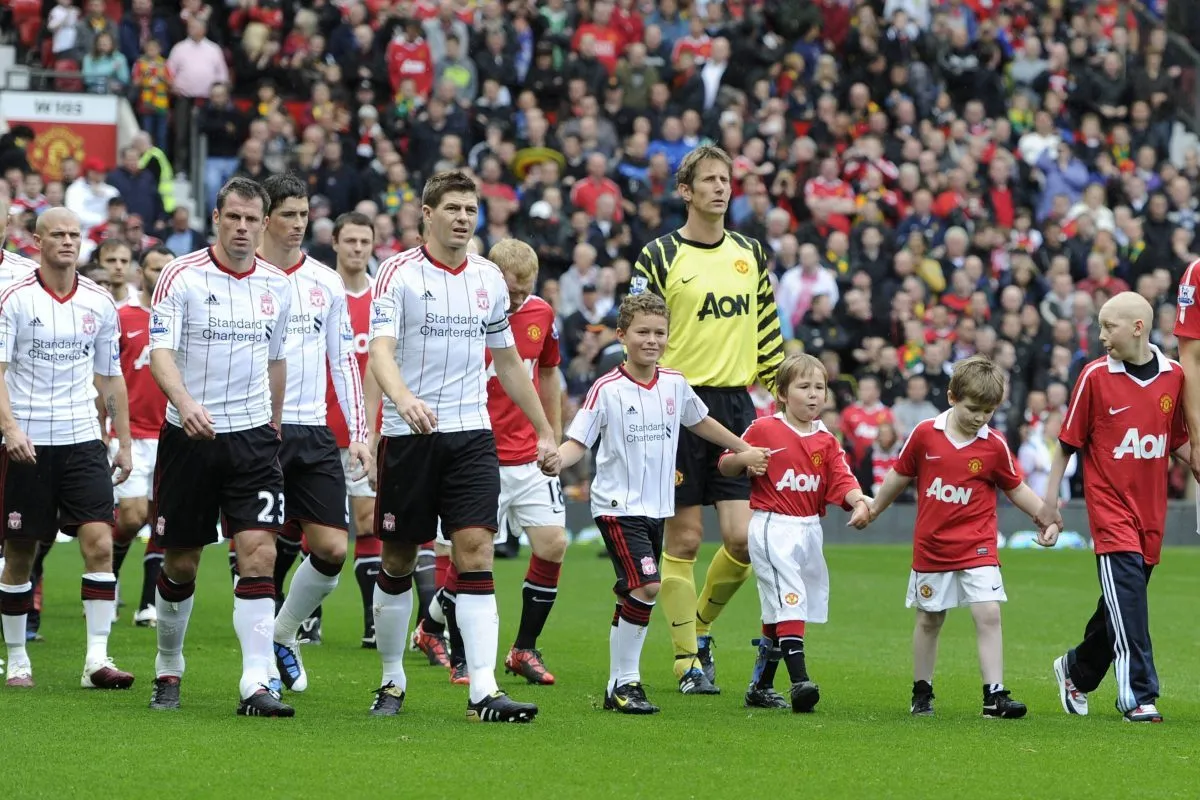 Steven Gerrard of Liverpool and Nemanja Vidic of Manchester United walk their teams out in the Premier League