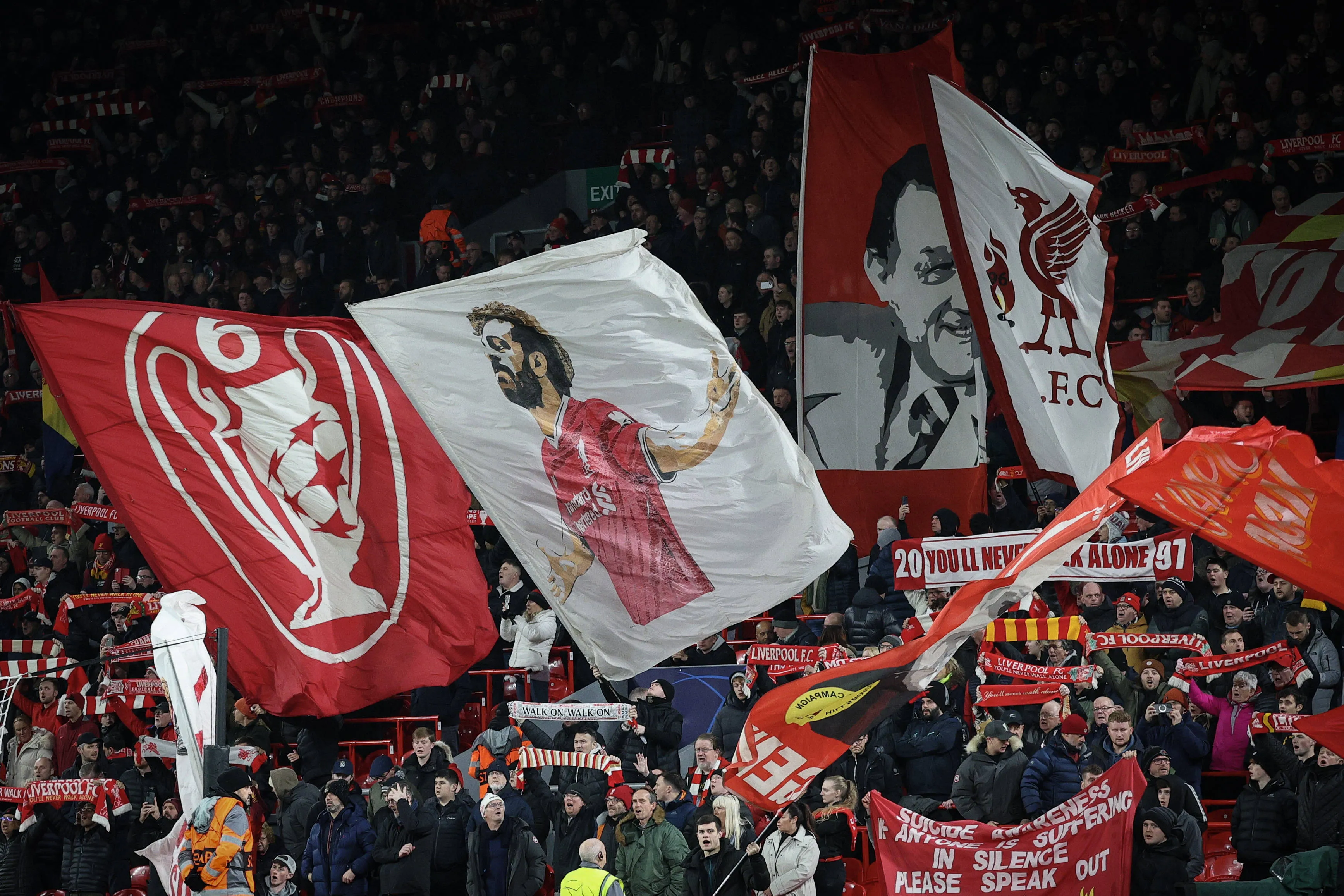 Liverpool fans with flags and banners in the Kop