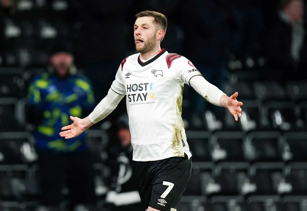 Derby fans on the pitch.