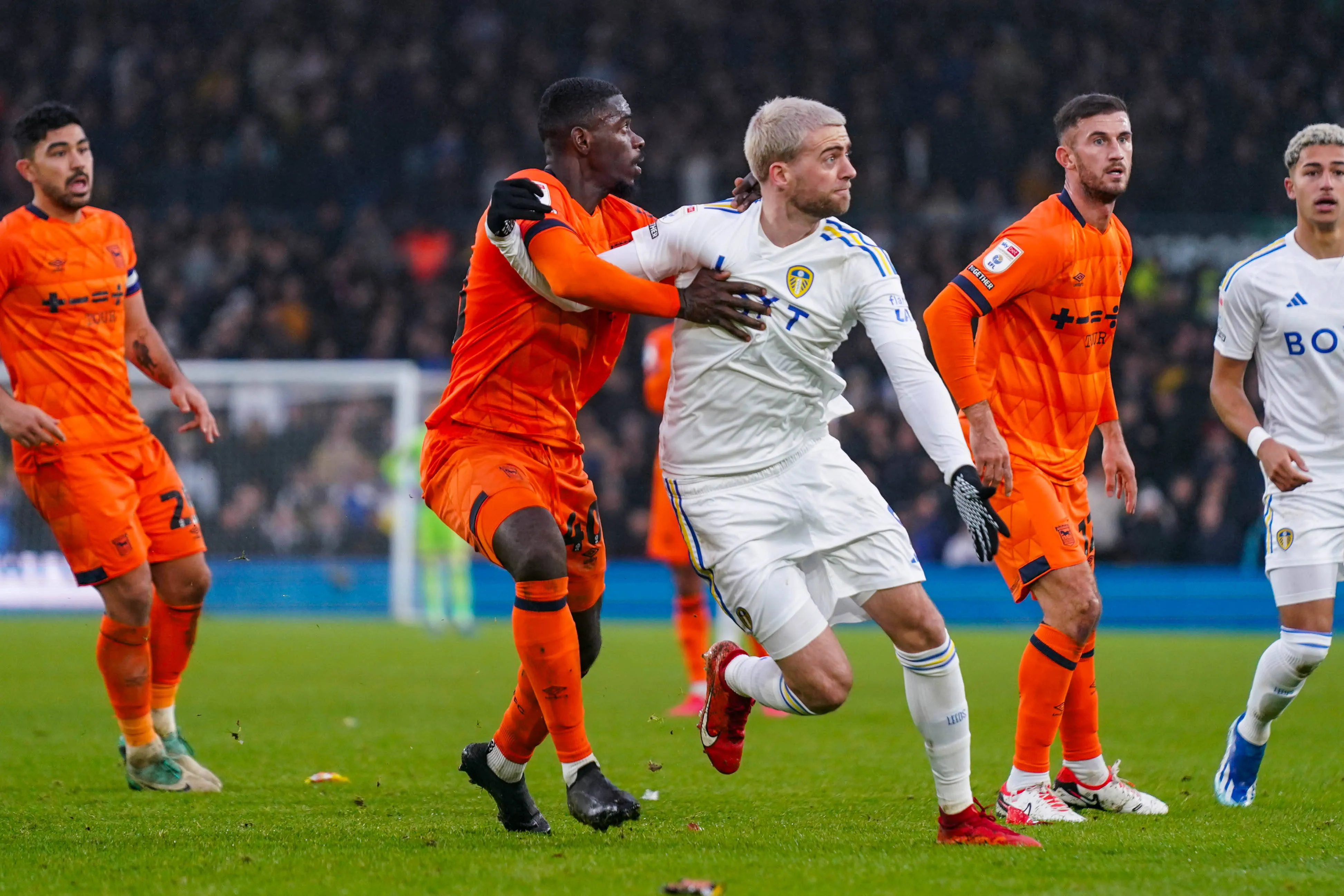 Leeds United forward Patrick Bamford wrestles with Ipswich Town defender Axel Tuanzebe