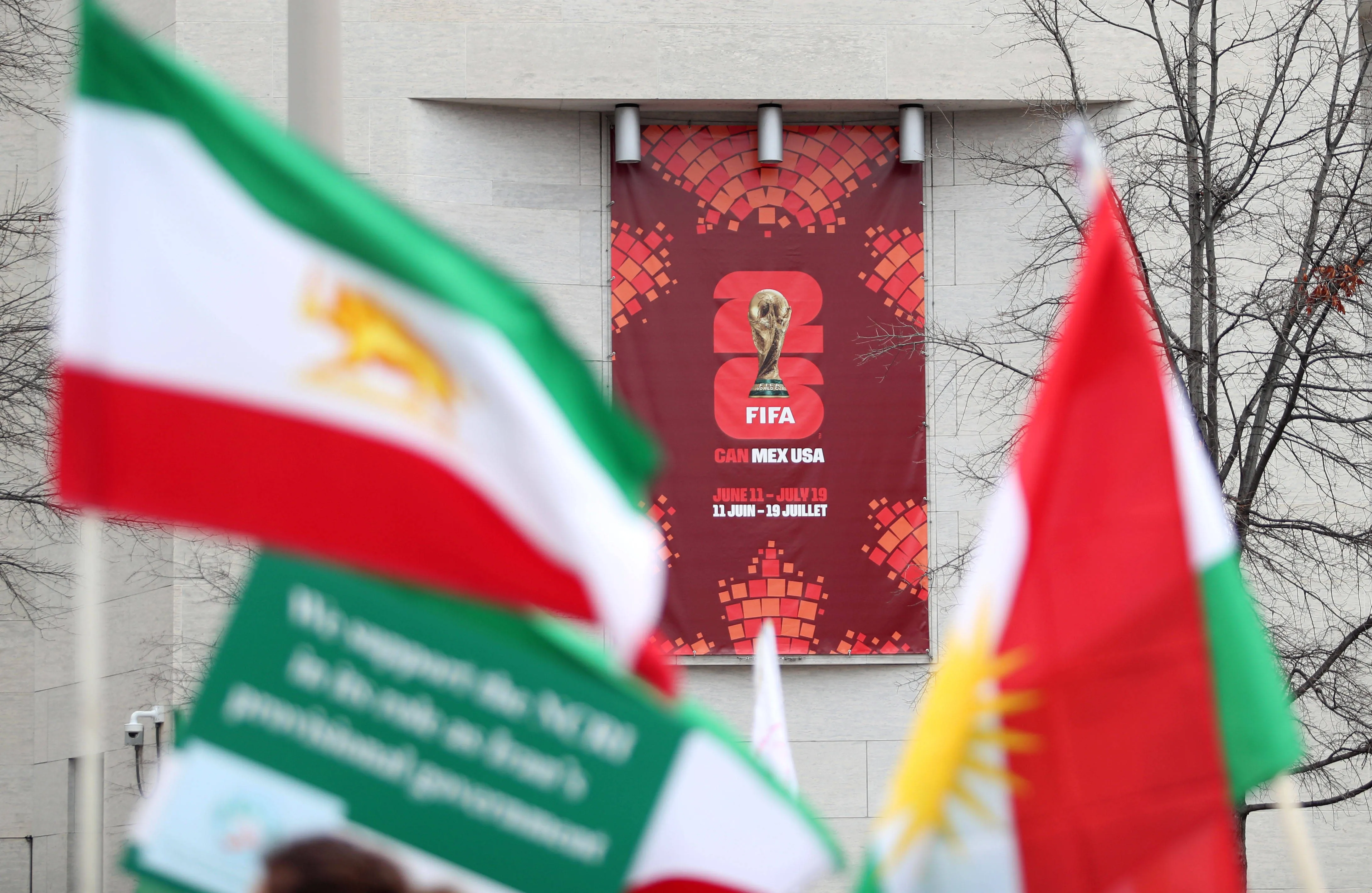 Iran flags are seen next to a FIFA World Cup 2026 poster during an anti-Iranian regime rally in Washington, DC, USA