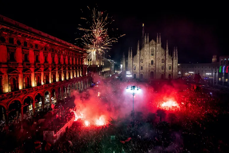 Milan Cathedral with AC Milan fans celebrating their league title in 2022 | San Siro away section - Newcastle fans guide to Milan away