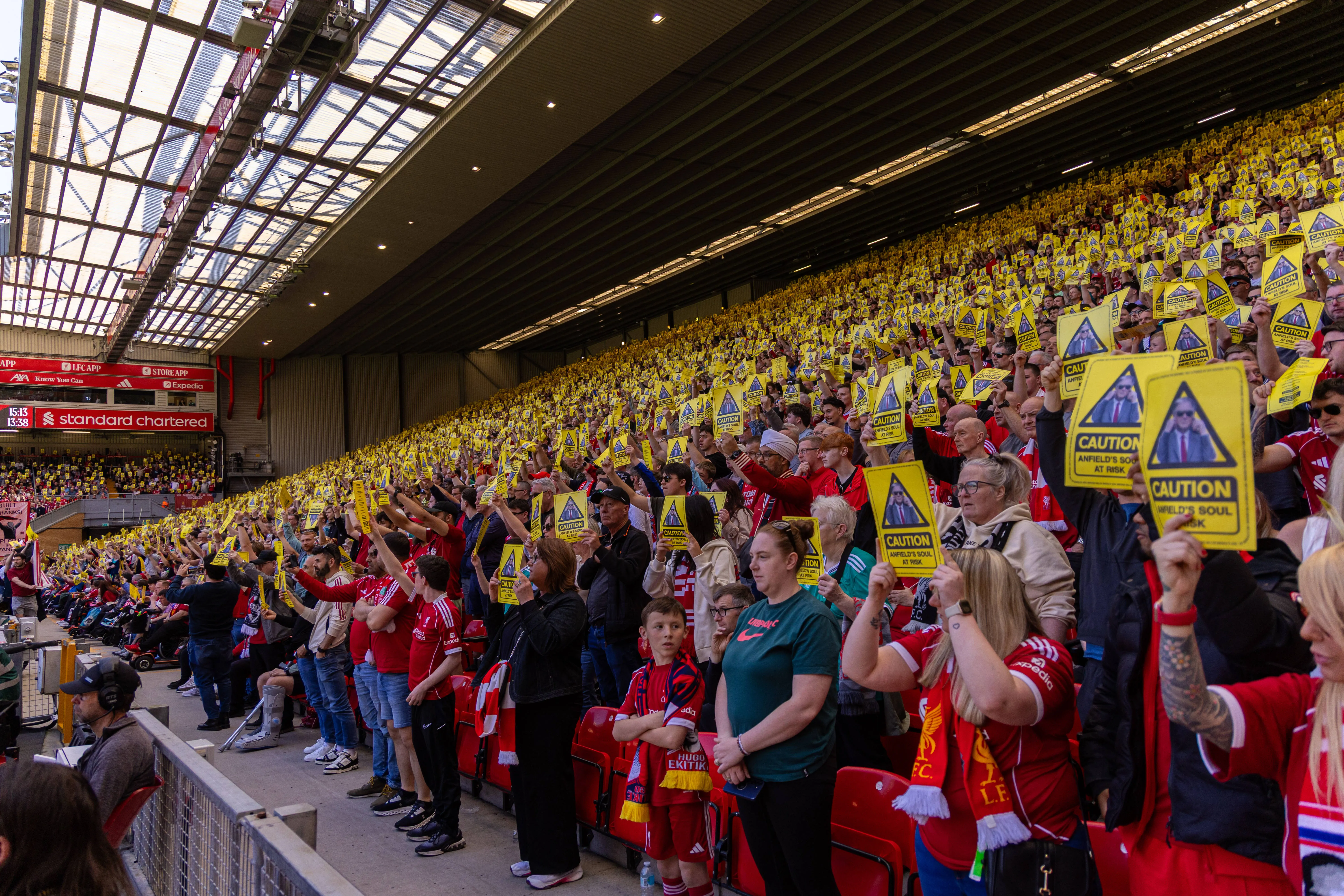 Liverpool supporters hold up a yellow card in protest of the proposed ticket price increases