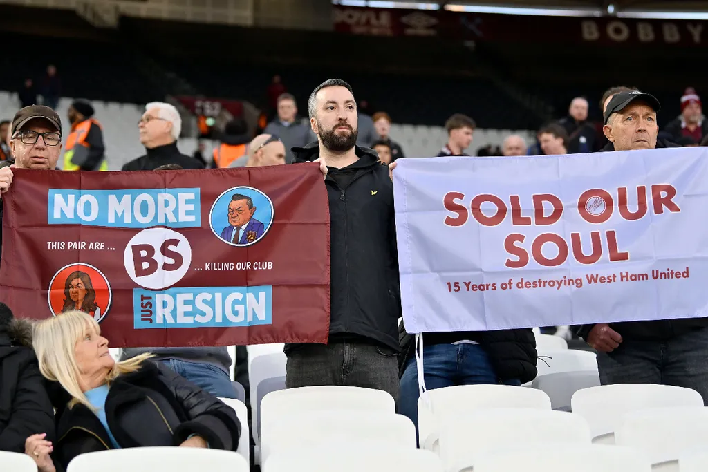 West Ham fans holding up protest signs during their 40-minute sit-in after the Newcastle game. 