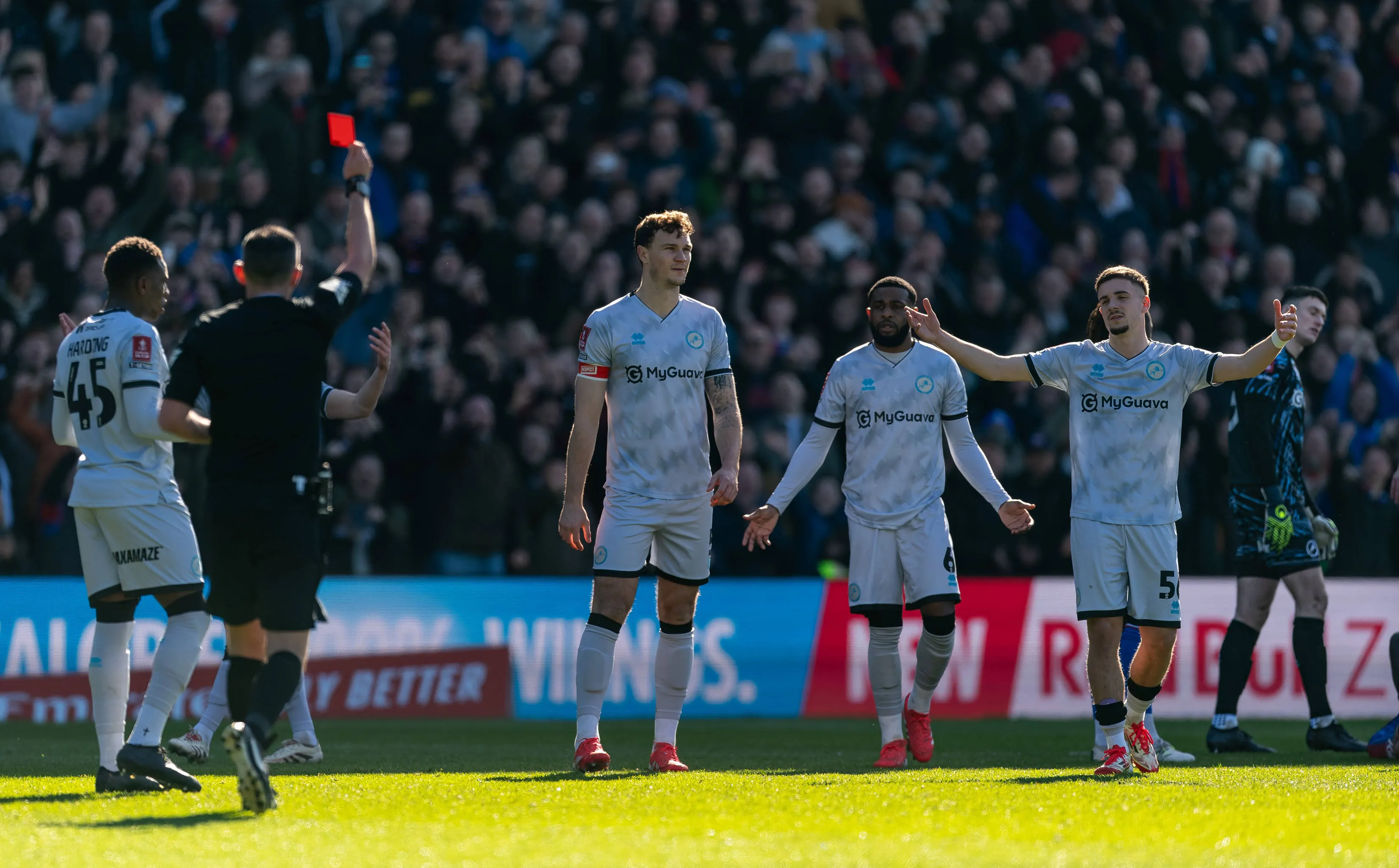 Referee brandishes a red card to Liam Roberts of Millwall after foul on Palace striker Jean-Philippe Mateta