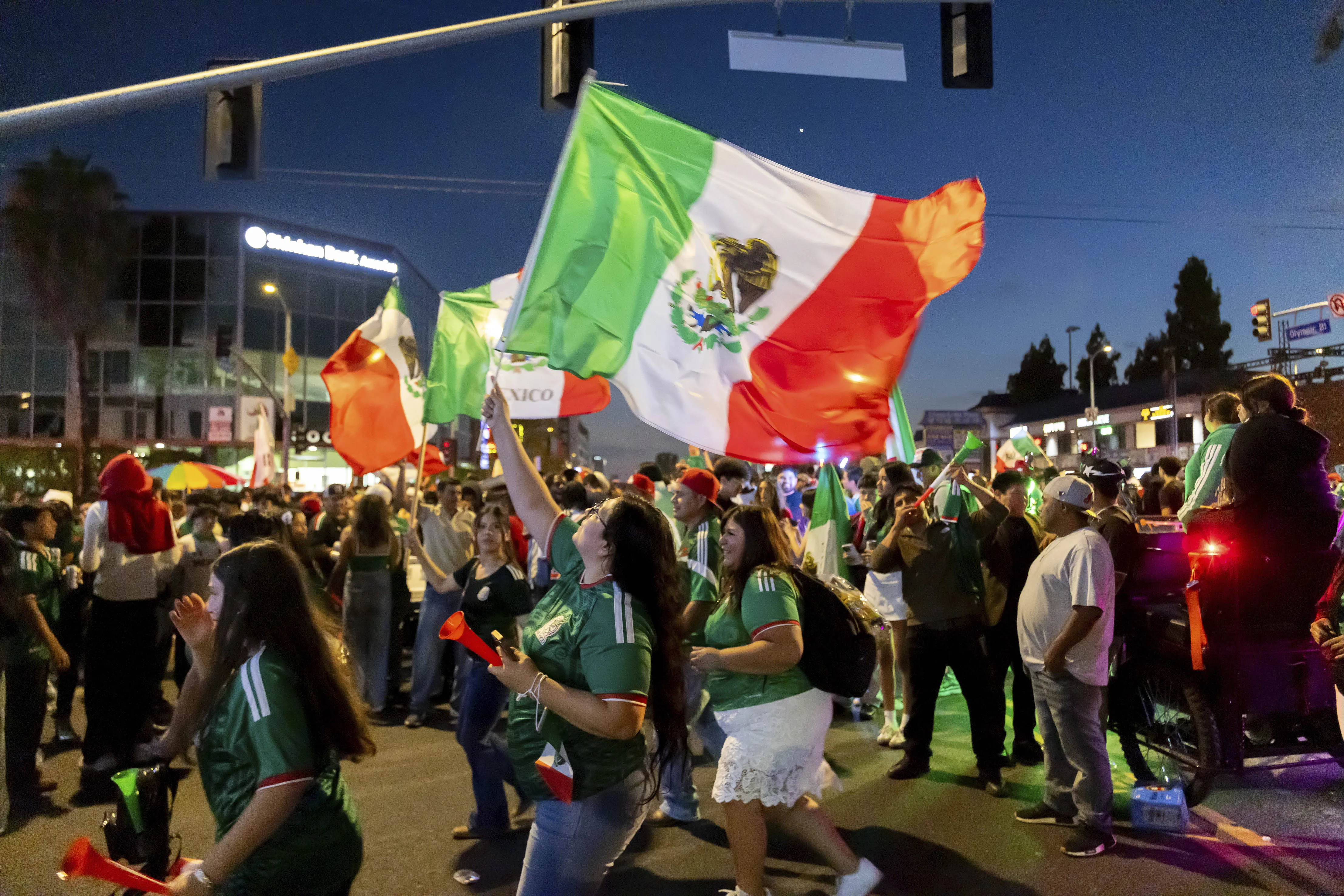 Mexico fans celebrate in the streets after beating South Korea